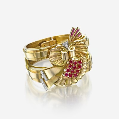 Lot 16 - A Retro eighteen karat gold, ruby, and diamond bangle bracelet