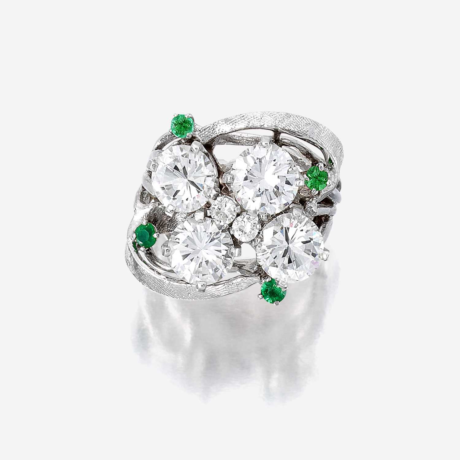 Lot 95 - A diamond, green stone, and fourteen karat white gold ring
