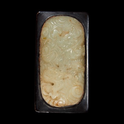 Lot 103 - A Chinese celadon jade libation cup, Yi, and a carved grey-white jade oval "Dragon" plaque