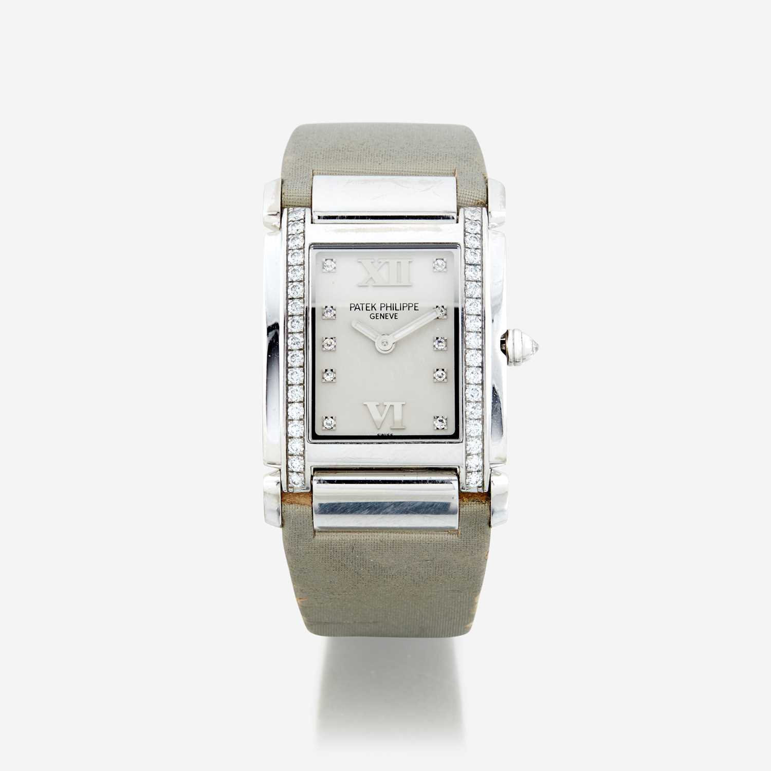 Lot 126 - A lady's eighteen karat white gold and diamond, strap wristwatch, Patek Philippe