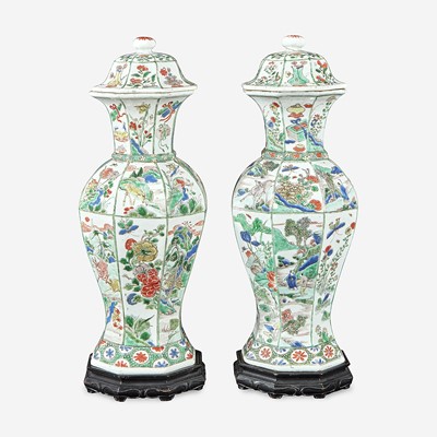 Lot 42 - A pair of Chinese famille verte-decorated octagonal baluster vases and covers