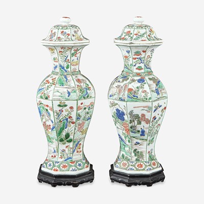 Lot 42 - A pair of Chinese famille verte-decorated octagonal baluster vases and covers