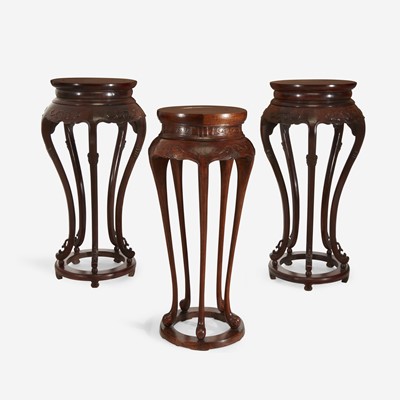 Lot 53 - A pair of Chinese hardwood circular stands, together with a similar Chinese carved hardwood circular stand