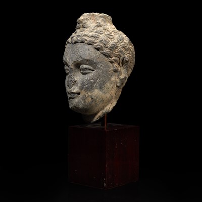 Lot 157 - A carved schist head of a Buddha, Gandhara 健陀罗片岩佛首