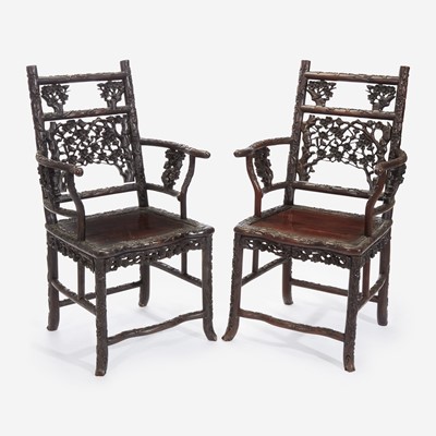 Lot 58 - An unusual pair of Chinese carved hardwood armchairs 中国硬木扶手椅一对