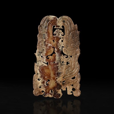 Lot 121 - A Chinese archaistic carved beige and brown jade plaque 高古风格棕黄玉佩
