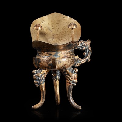Lot 131 - A Chinese silver-gilt tripod libation cup