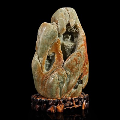 Lot 159 - A Large Chinese carved celadon and russet jade mountain and wood stand