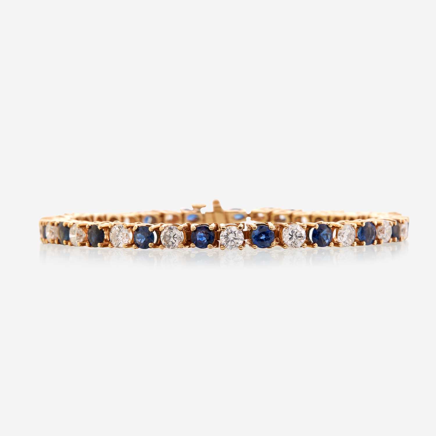 Lot 41 - A diamond, sapphire, and fourteen karat gold bracelet
