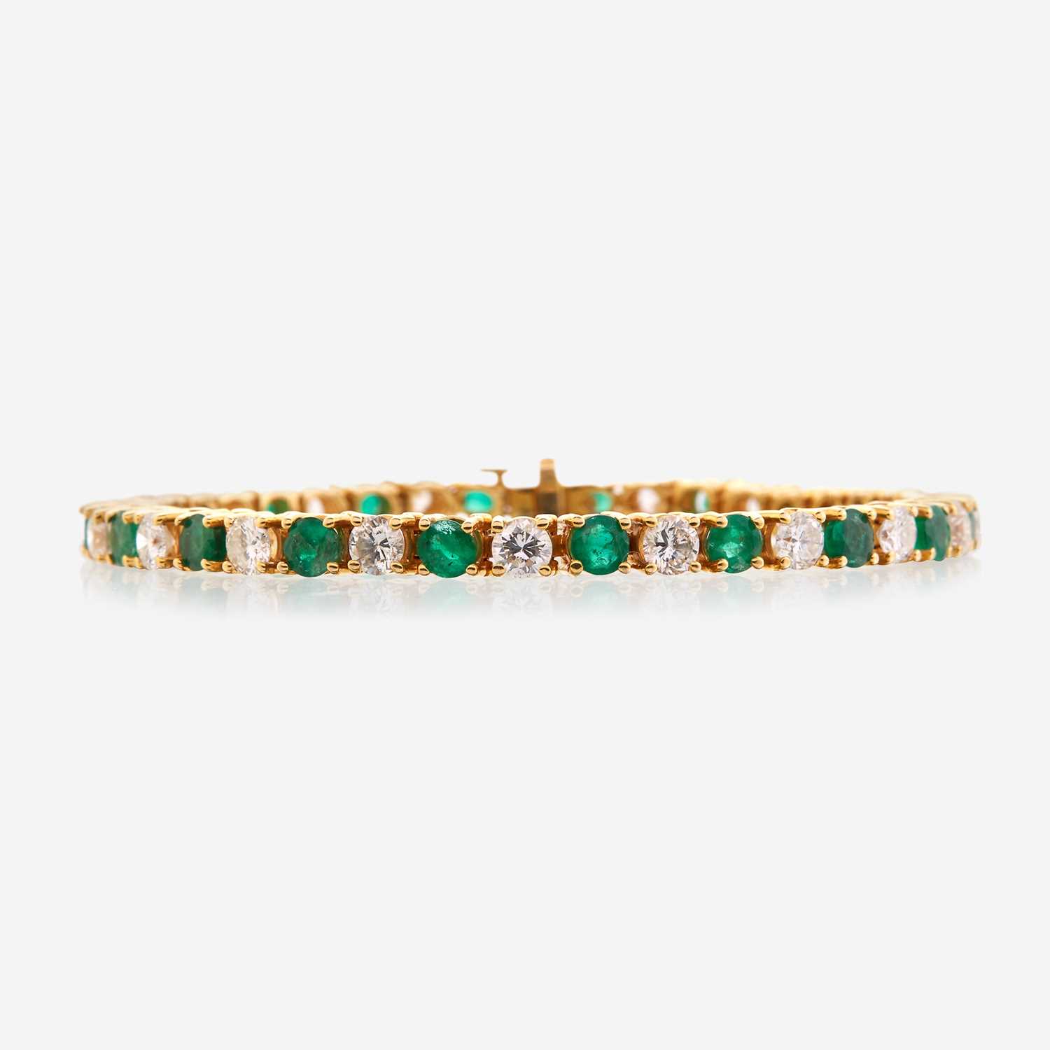 Lot 39 - A diamond, emerald, and fourteen karat gold bracelet
