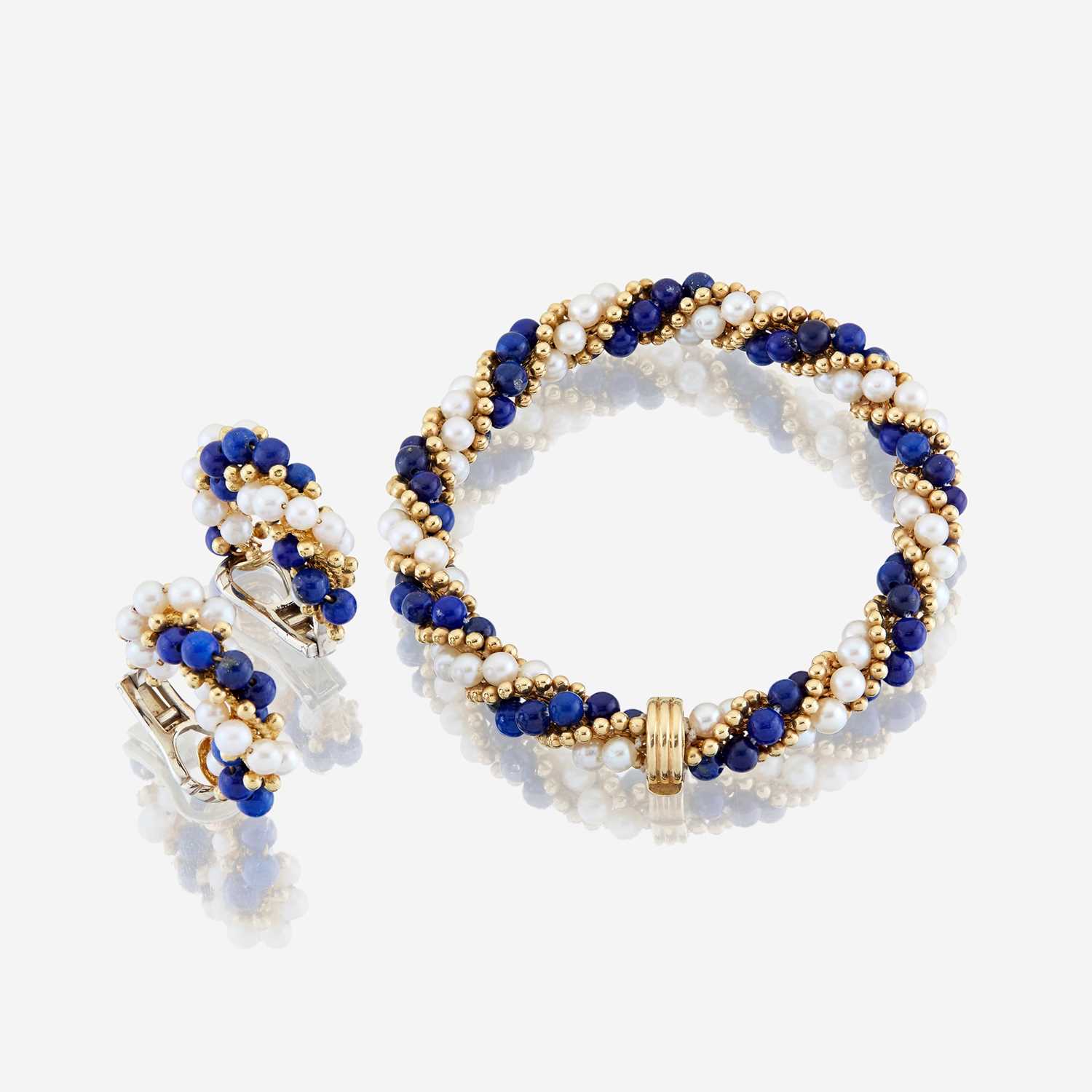 Lot 29 - A lapis lazuli, cultured pearl, and eighteen karat gold bracelet with similar ear clips
