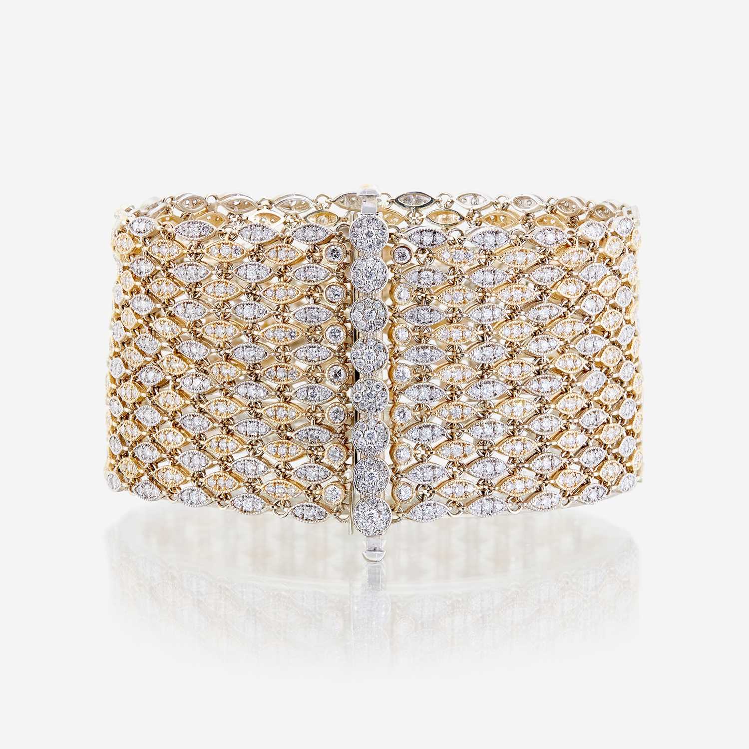 Lot 42 - A bicolor fourteen karat gold and diamond bracelet
