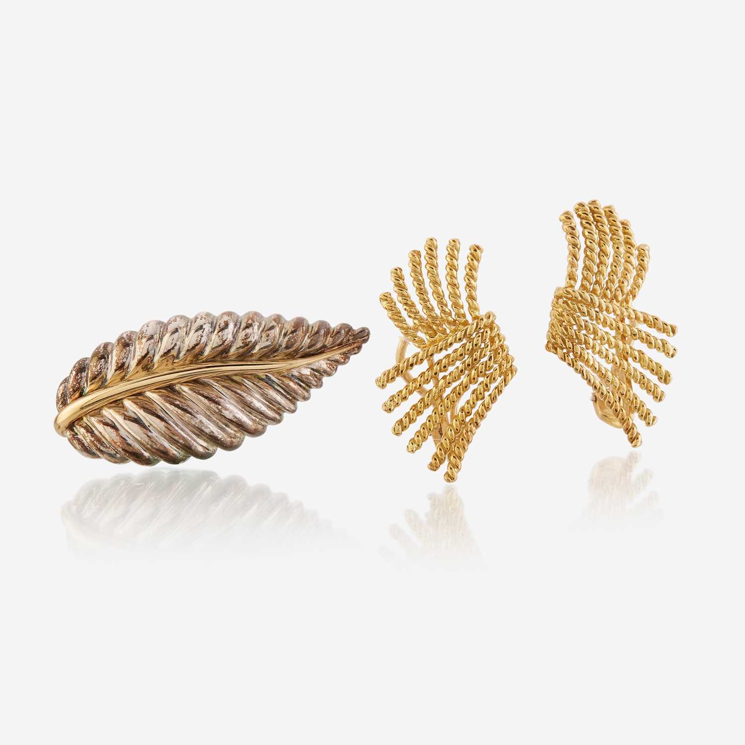 Lot 106 - A pair of eighteen karat gold ear clips and a sterling silver and eighteen karat gold brooch, Tiffany & Co.