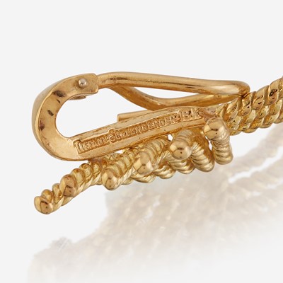 Lot 106 - A pair of eighteen karat gold ear clips and a sterling silver and eighteen karat gold brooch, Tiffany & Co.