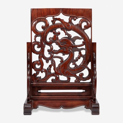 Lot 42 - A Chinese carved and pierced huanghuali "dragon" panel, in later hardwood stand 黄花梨镂雕龙纹木板 后配底座