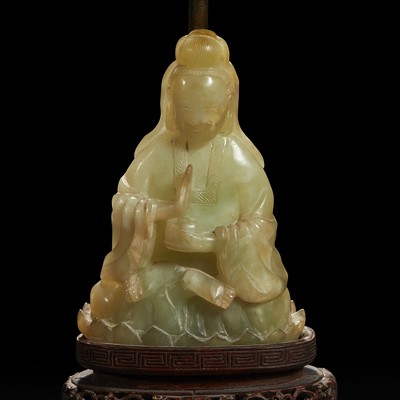 Lot 141 - A Chinese carved mottled celadon jade figure of Guanyin, mounted as a lamp 玉雕观音改装台灯