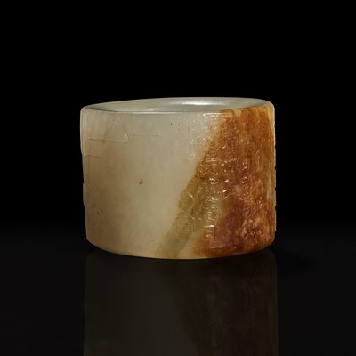Lot 126 - A large pale celadon and russet jade archer ring with Imperial poem and hunting scene 乾隆御题诗狩猎图玉扳指