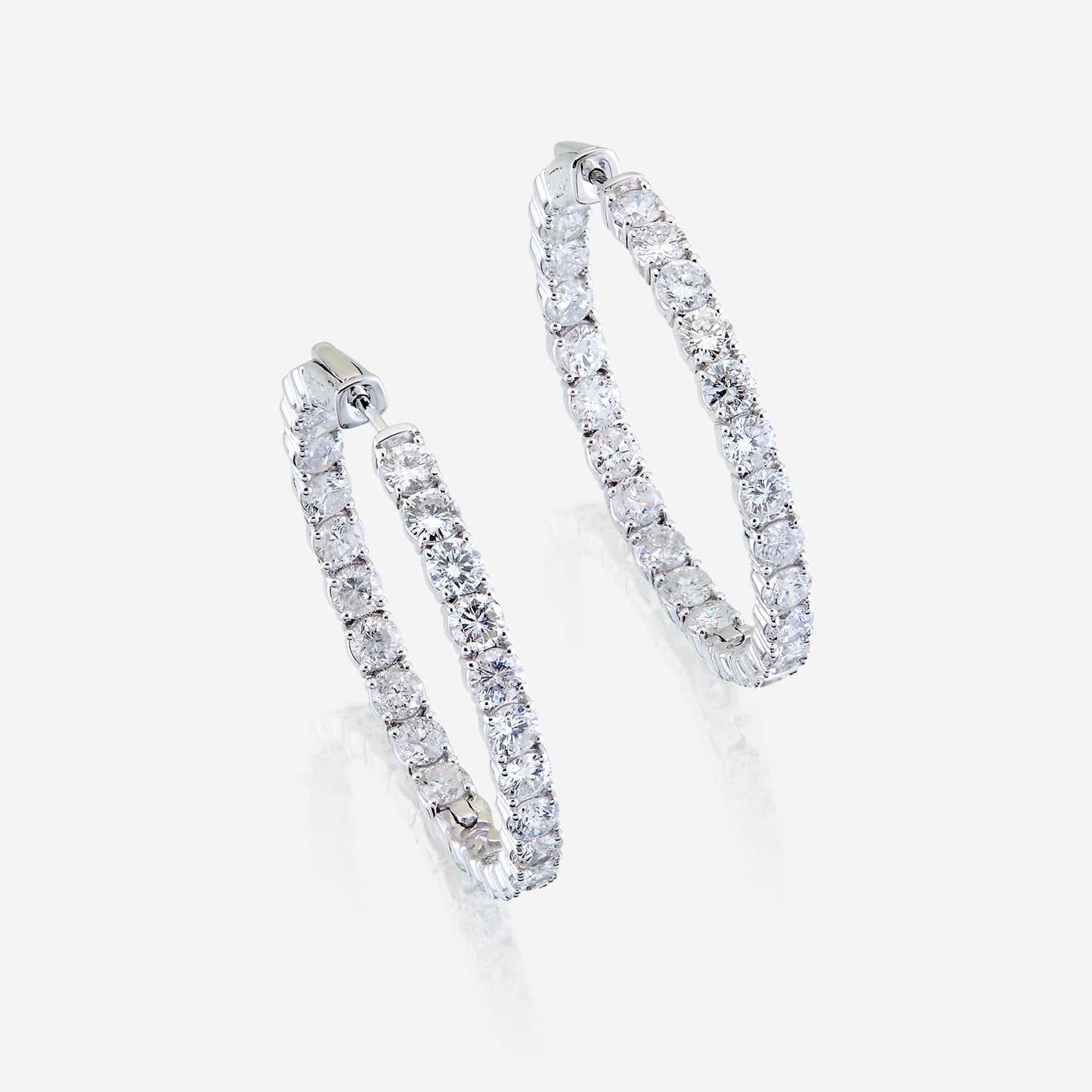 Lot 52 - A pair of diamond and fourteen karat white gold earrings