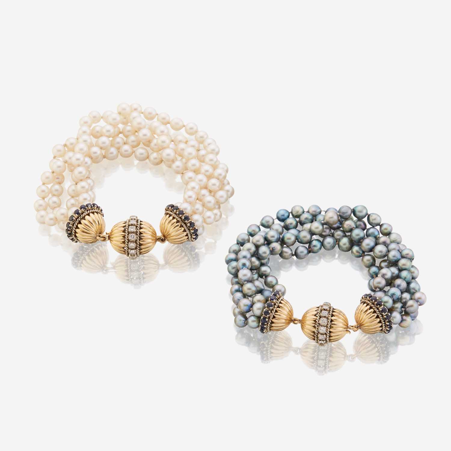 Lot 170 - A pair of cultured pearl, diamond, sapphire, and eighteen karat gold bracelets