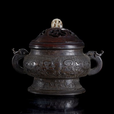 Lot 22 - A Chinese patinated bronze vessel with wood cover and jade finial 铜香炉及嵌玉木盖