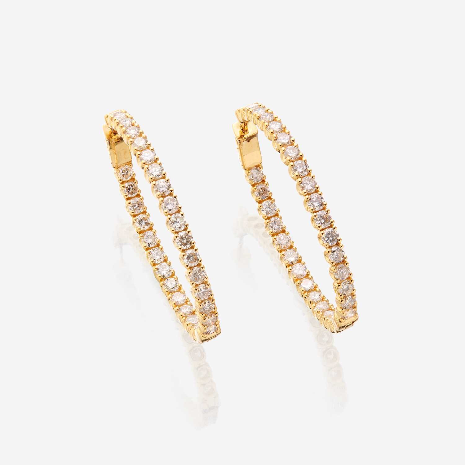 Lot 62 - A pair of diamond and fourteen karat gold earrings