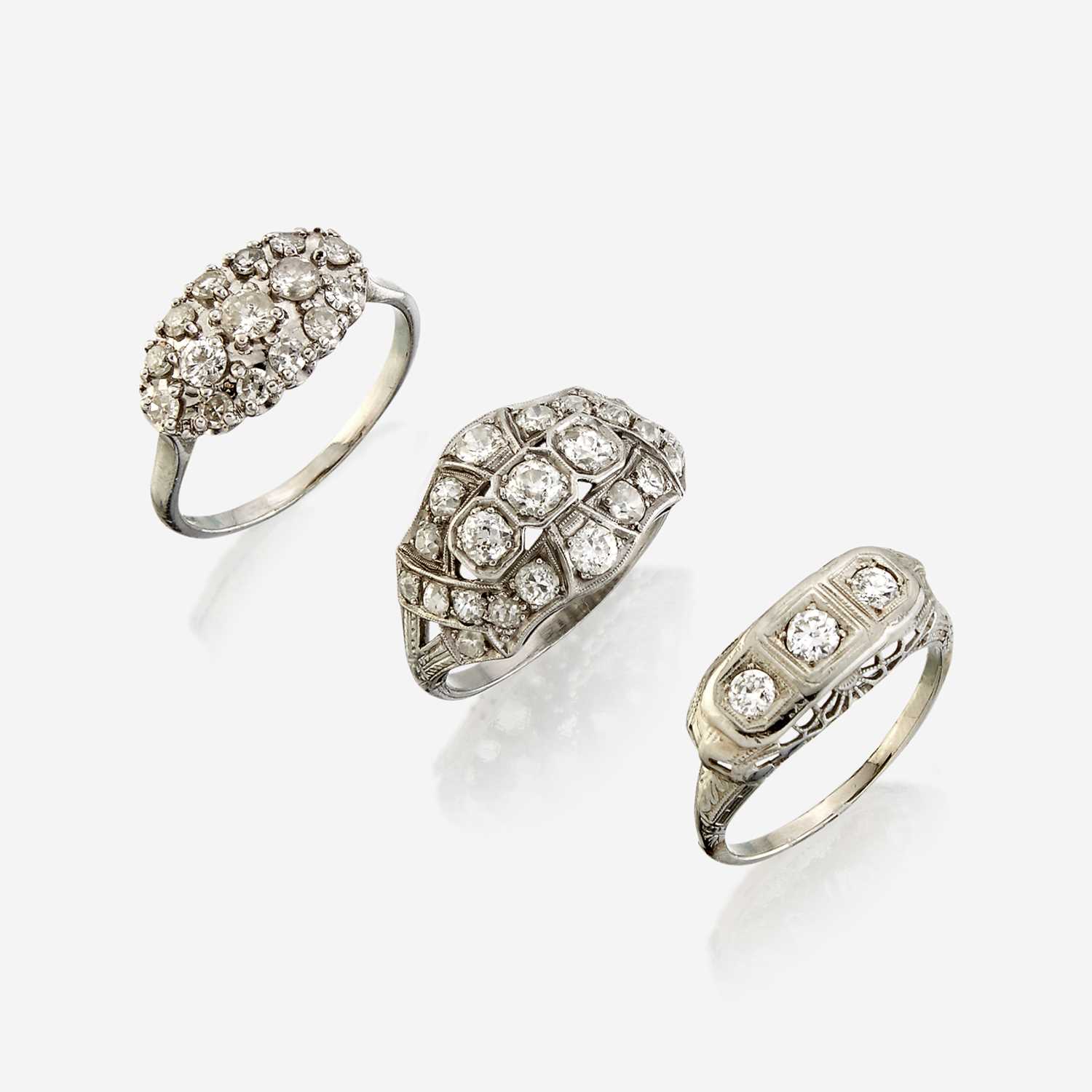 Lot 112 - A collection of three white metal and diamond rings