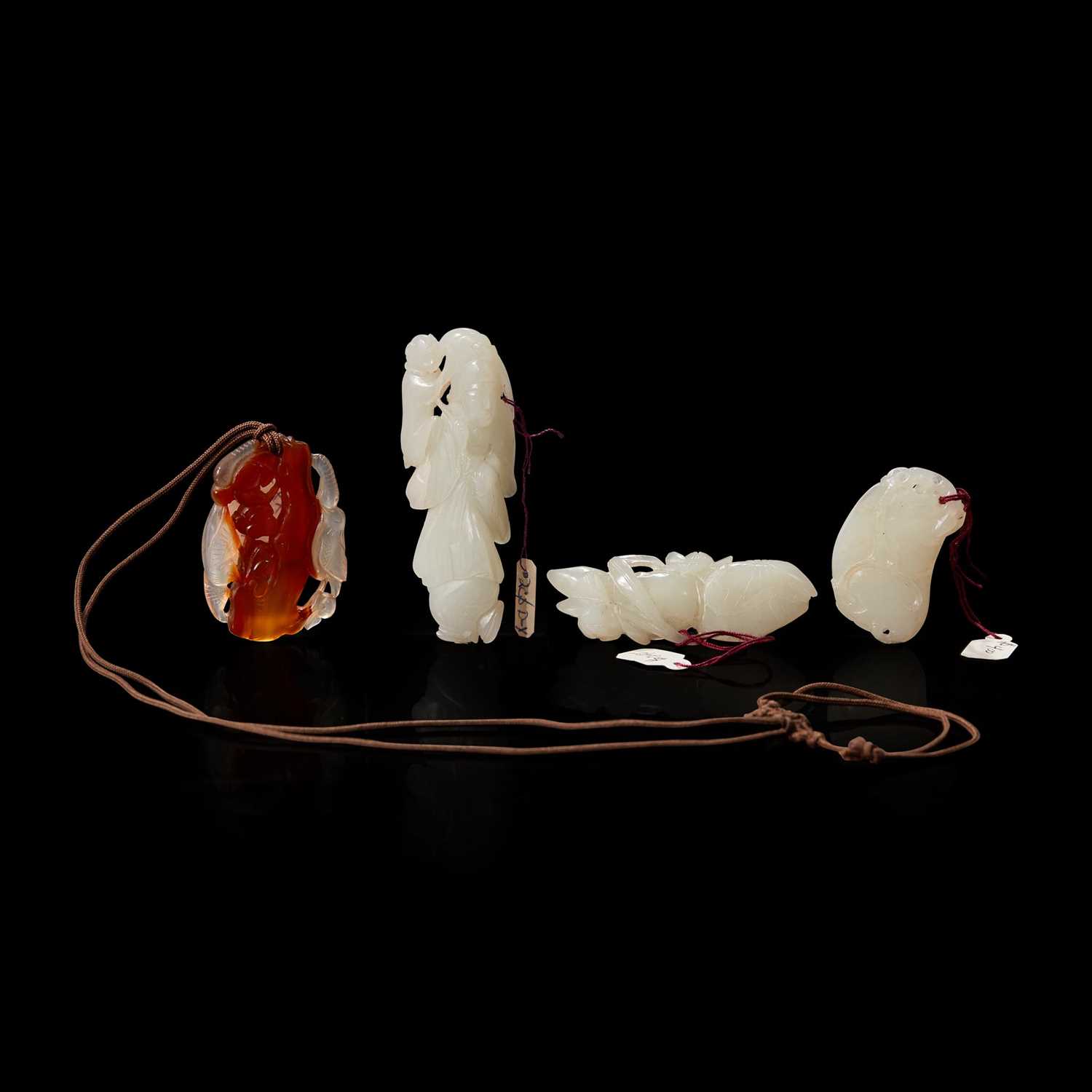 Lot 132 - A group of three Chinese white jade carvings and a carnelian pendant