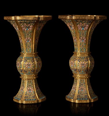 Lot 12 - An exceptional pair of Chinese champlevé cloisonné enamel gilt metal gu-form vases 铜鎏金锤鍱珐琅花觚一对