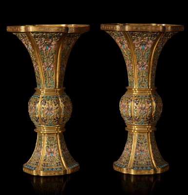 Lot 79 - An exceptional pair of Chinese champlevé cloisonné enamel gilt metal gu-form vases 铜鎏金锤鍱珐琅花觚一对