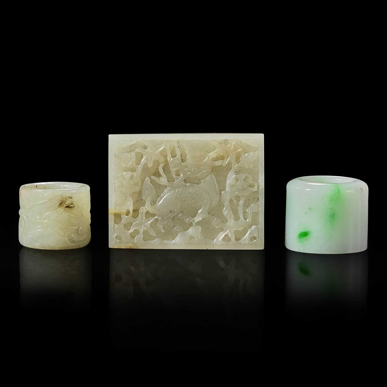Lot 6 - Two Chinese jade and jadeite thumb rings and a carved jade belt plaque 扳指及玉牌饰一组三件