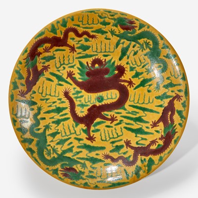 Lot 41 - A large Chinese yellow-ground “Dragons” charger