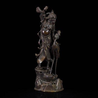 Lot 23 - A patinated bronze figure of a Daoist immortal with crane 道教仙人与鹤铜塑