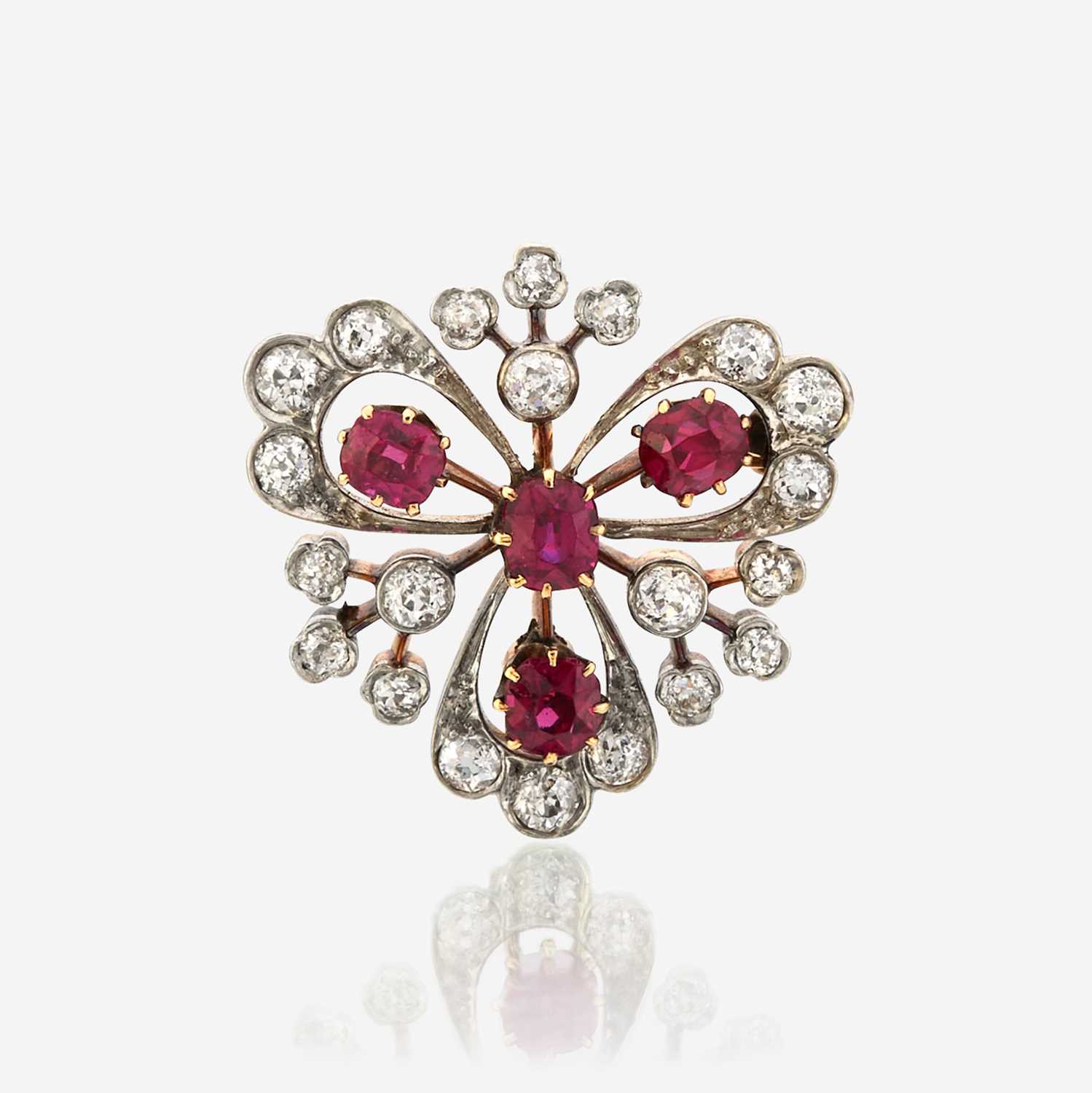 Lot 45 - A ruby, diamond, and platinum topped gold pendant/brooch