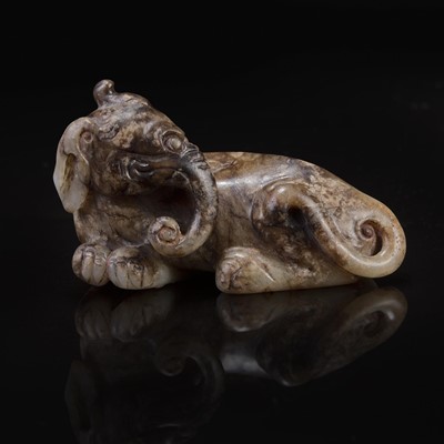 Lot 79 - A Chinese brown and beige jade carving of a Baku 玉雕貘