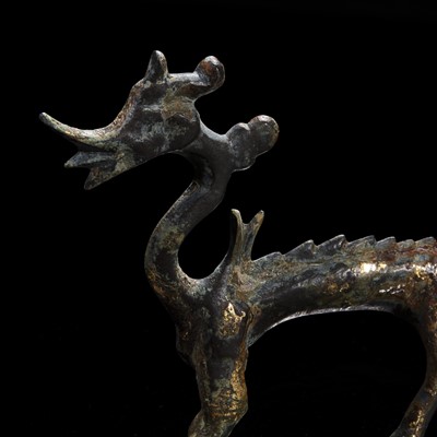 Lot 76 - A small Chinese gilt-bronze figure of a striding dragon 铜鎏金行龙