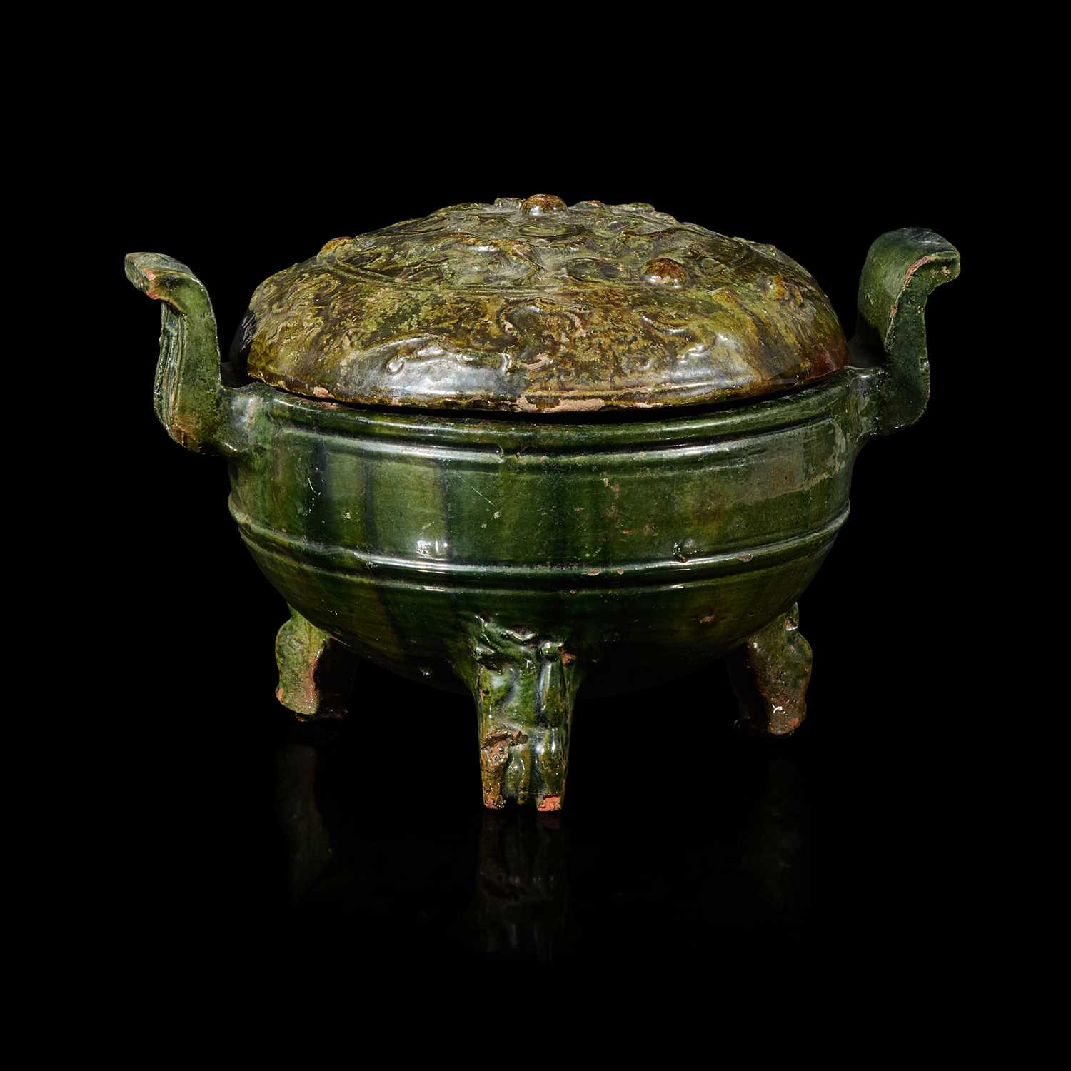 Lot 89 - A Chinese green-glazed red pottery tripod vessel and cover, Ding