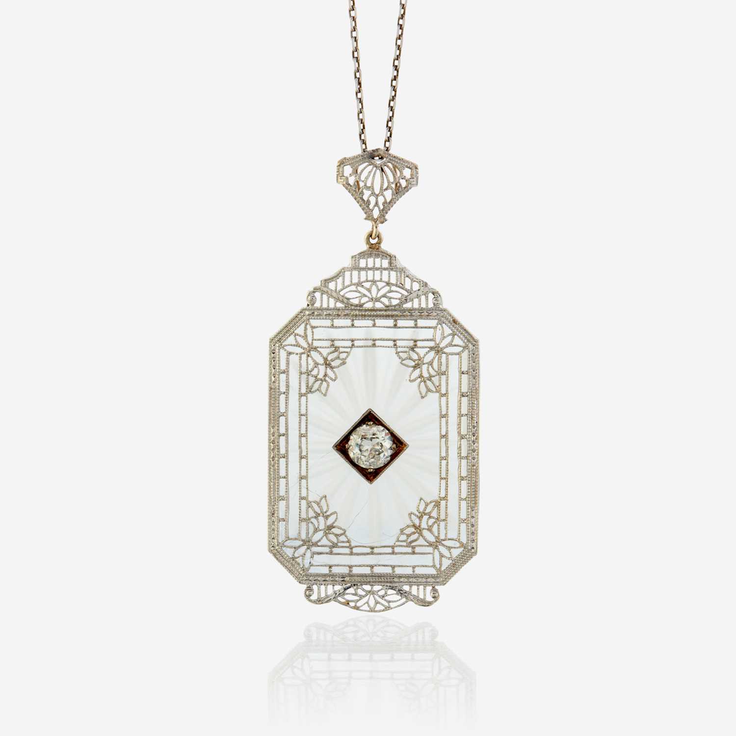 Lot 26 - A diamond, rock crystal, and white metal pendant