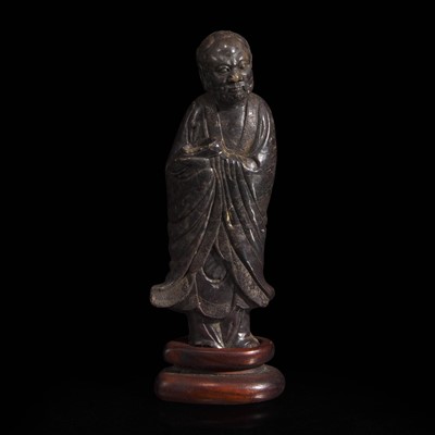 Lot 69 - A Chinese carved dark soapstone Luohan 寿山石雕罗汉