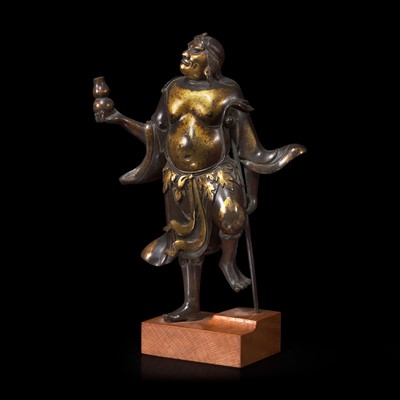 Lot 35 - A finely modeled Chinese parcel-gilt and patinated bronze figure of Li Tieguai 部分漆金加画铁拐李铜造像