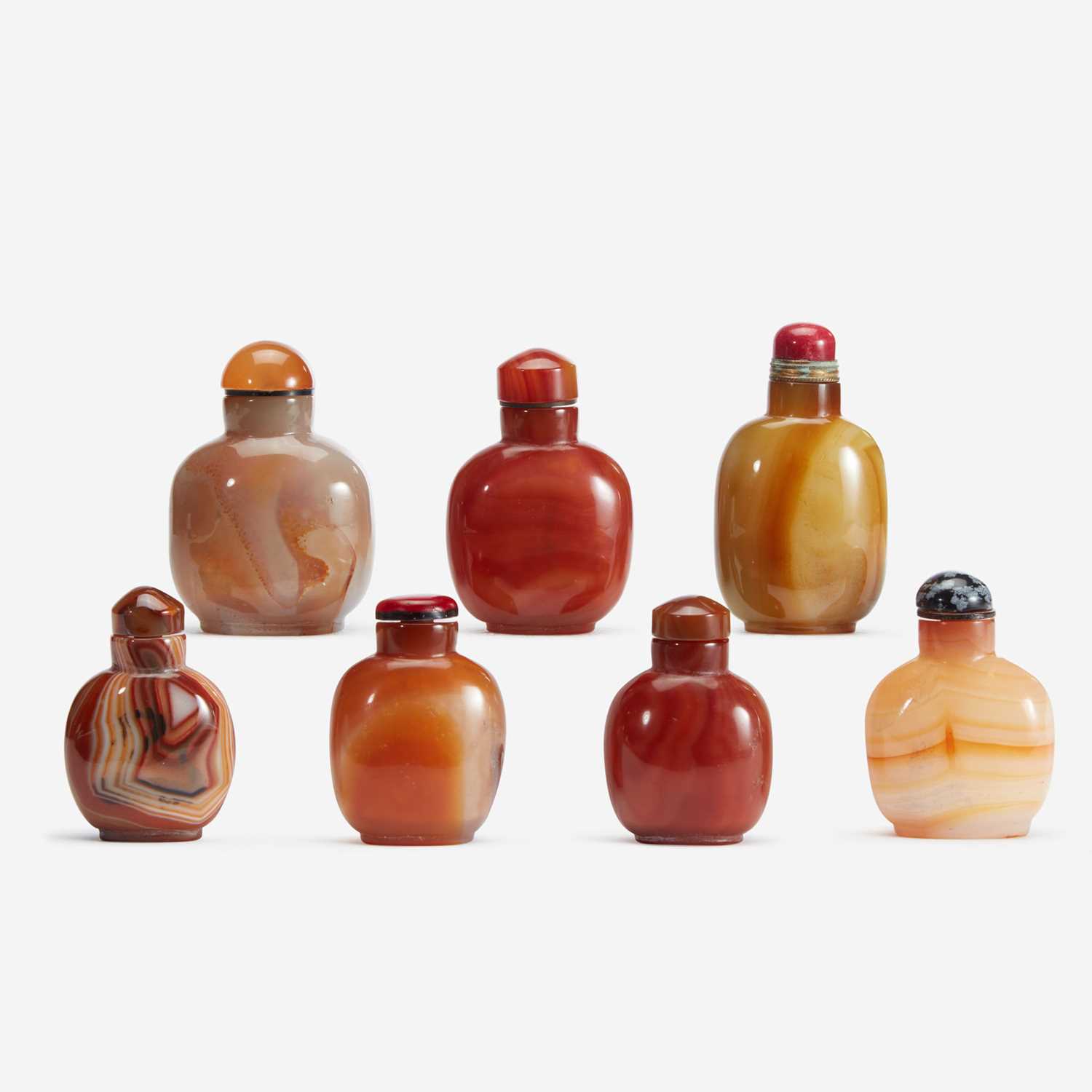 Lot 184 - An assorted group of seven Chinese carnelian and agate snuff bottles