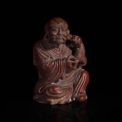 Lot 26 - A Chinese finely-carved bamboo luohan and lion 竹雕笑狮罗汉