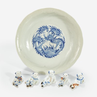 Lot 219 - Five Hirado porcelain small figures of boys and a Nabeshima style molded “Dragon” dish
