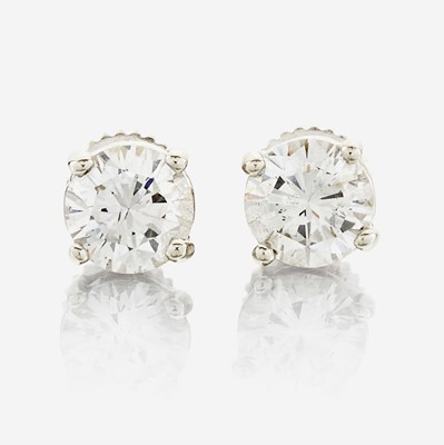 Lot 141 - A pair of diamond and white metal earrings