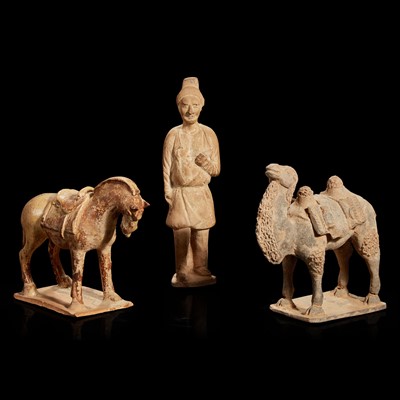 Lot 95 - Three Chinese pottery figures of an attendant, a horse and a camel