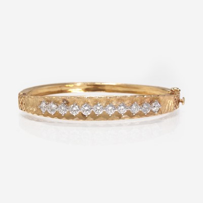 Lot 259 - A 14K Gold and Diamond Bangle Bracelet