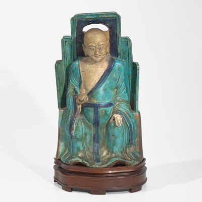 Lot 28 - A Chinese turquoise and blue glazed figure of a seated Luohan 松石绿地罗汉坐像