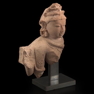 Lot 11 - An Indian carved pinkish-buff sandstone bust of a female deity 砂岩雕女神像