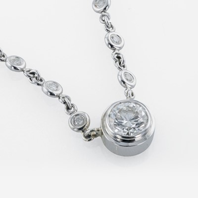 Lot 66 - A 14K, white gold diamond bezel set necklace