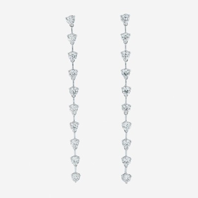 Lot 65 - A pair of 18K white gold and diamond dangle earrings