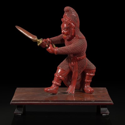 Lot 82 - An unusual and finely-carved cinnabar lacquer figure of a warrior 朱漆武士像
